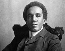 A photograph of Samuel Coleridge-Taylor seated looking at the camera.